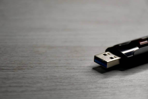 USB flash drive USB flash drive on the wood table with copy space wooden flash drive stock pictures, royalty-free photos & images