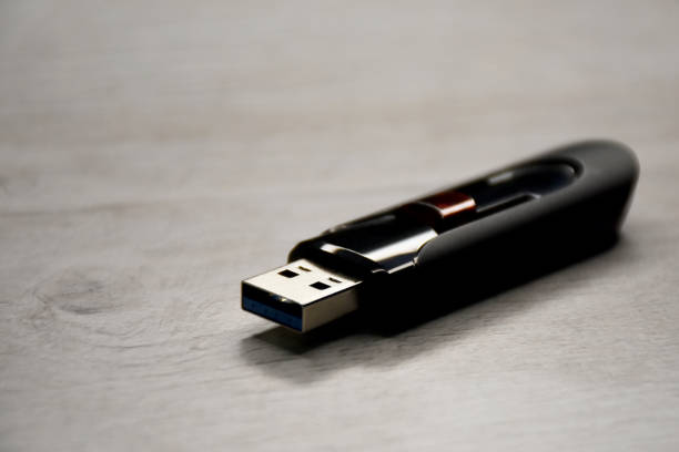 USB flash drive USB flash drive on the wood table with copy space wooden flash drive stock pictures, royalty-free photos & images