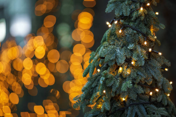 istock Full Frame Shot Of Illuminated Christmas decorations on Christmas tree against defocused bokeh background. Winter Holidays Concept 1454243741