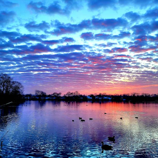 istock Blue cloudy lake sunrise 1454245423