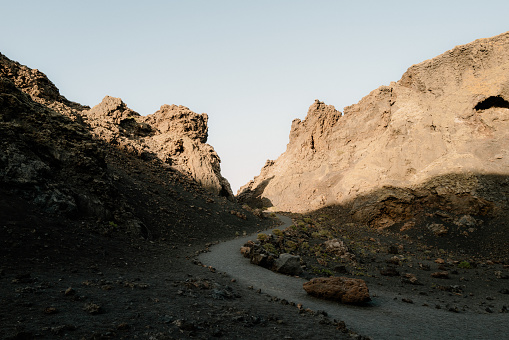 Trail runs through, towards distant volcano