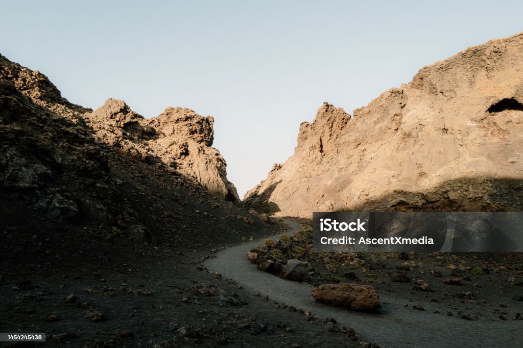 Scenic view of desert landscape Trail runs through, towards distant volcano Mountain Stock Photo