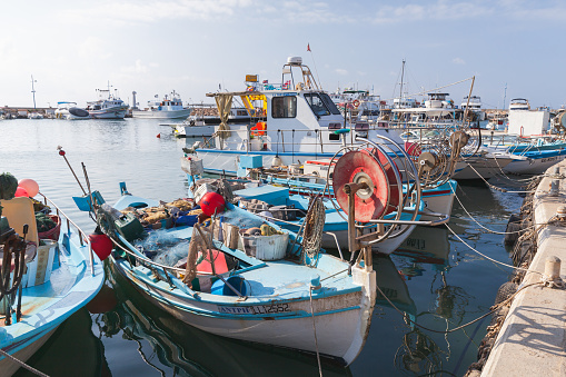 Ayia Napa, Cyprus - June 11, 2018: Greek fishing boats are moored at Agia Napa marina on a sunny day