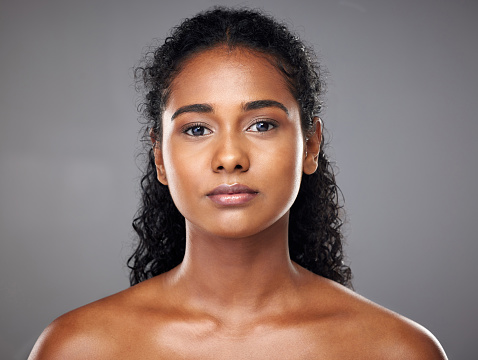Face, beauty and skincare of a woman from India with glowing, wellness and skin health. Portrait of a young Indian person after a cosmetic, dermatology of glowing body treatment looking radiant