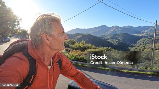 istock Man rides bike through Italian countryside 1454248641
