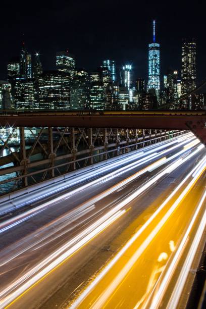 istock Light trail on the road in a modern illuminated city 1454248895