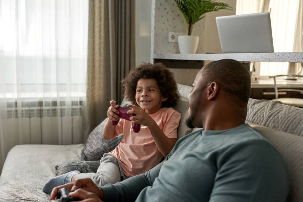 istock Black dad look at son during they play video game 1454248958