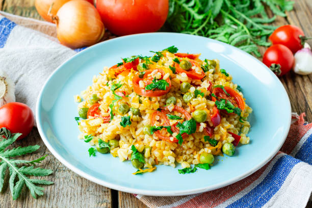 istock Bulgur with carrots, onions, bell peppers and green peas 1454249896