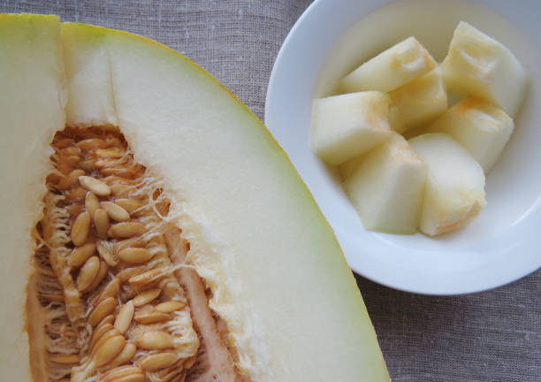 istock Cut open cantaloupe melon , sweet melon with seeds close up 1454251048
