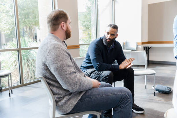 Two diverse men have intense conversation before meeting stock photo