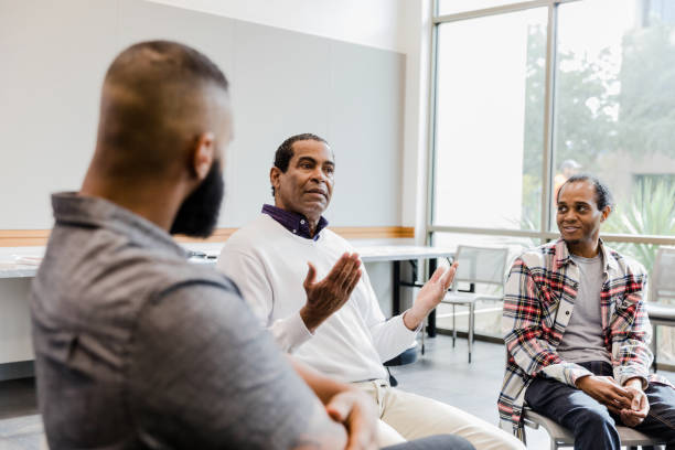 istock Serious mature man asks question in meeting 1454251303