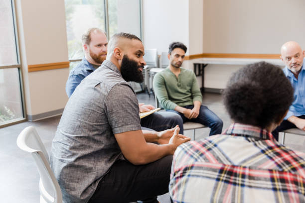 istock Multiracial group of men listen to unrecognizable man sharing 1454251318