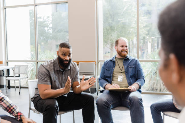 istock Diverse men laugh and joke in group therapy 1454251319