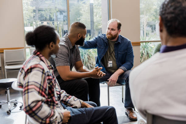 istock In group therapy, unrecognizable man listens as counselor gives advice 1454251326