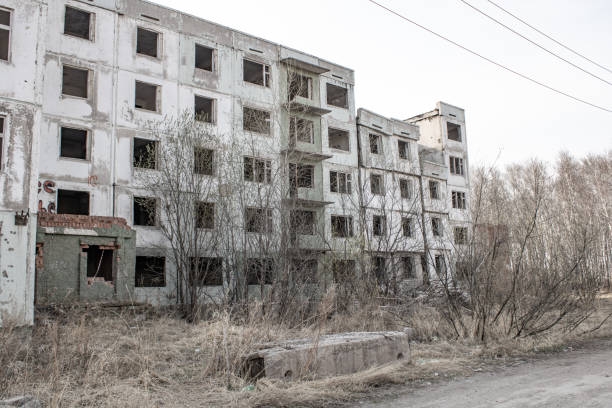 istock Dilapidated residential building with empty windows, collapsed roof 1454252604