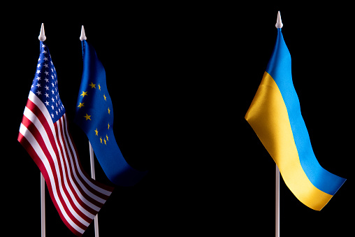 The flag of Ukraine of the United States and Europe on a black background. The concept of support for Ukraine in difficult times. Relations between countries.