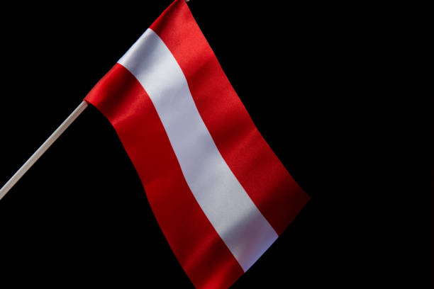 istock The Latvian flag on a black background is developing and flying in the wind 1454254939