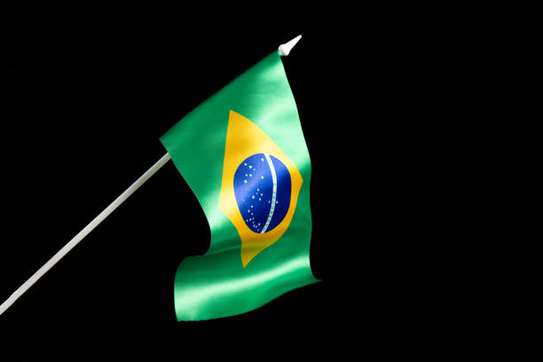 istock The Brazilian flag on a black background developing and fluttering in the wind 1454255043