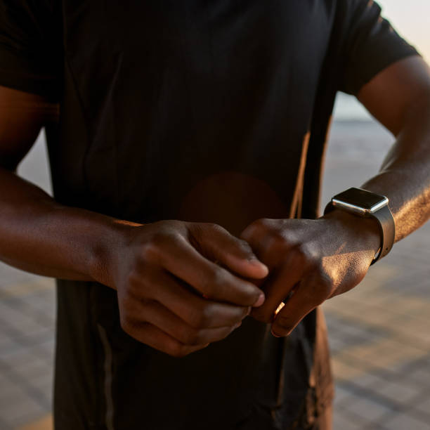 istock Partial of african sports man using smartwatch 1454257465