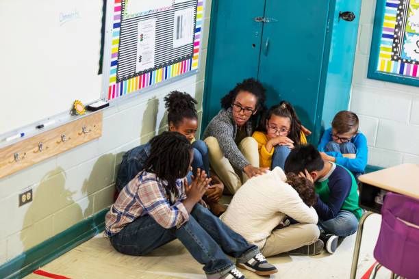 istock Teacher and children doing school safety drill, lockdown 1454257536