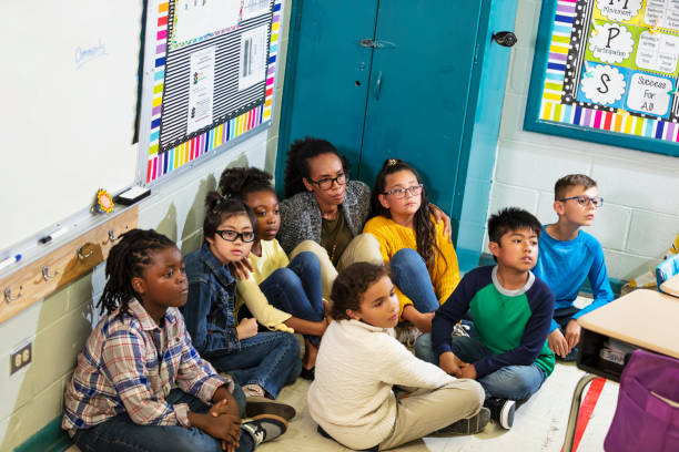 istock Teacher and children doing school safety drill, lockdown 1454257593