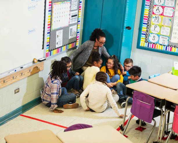 istock Teacher and children doing school safety drill, lockdown 1454257595
