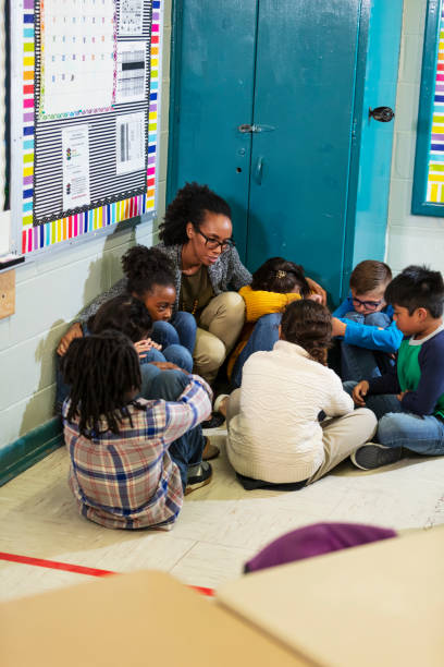 istock Teacher and children doing school safety drill, lockdown 1454257654