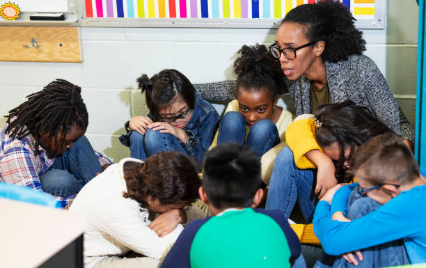 istock Teacher and children doing school safety drill, lockdown 1454257710