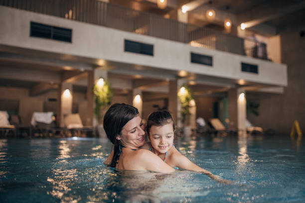 istock Mother and daughter in the pool 1454258589
