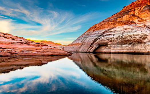 Beautiful view of sandstone wall reflection and water at Lake Powell reservoir in Utah and Arizona.  Part of Colorado River in the Glen Canyon National Recreation Area.