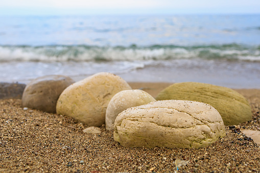 Very beautiful background or backdrop of huge pebbles on the resort beach, selective focus with copy space for text.
