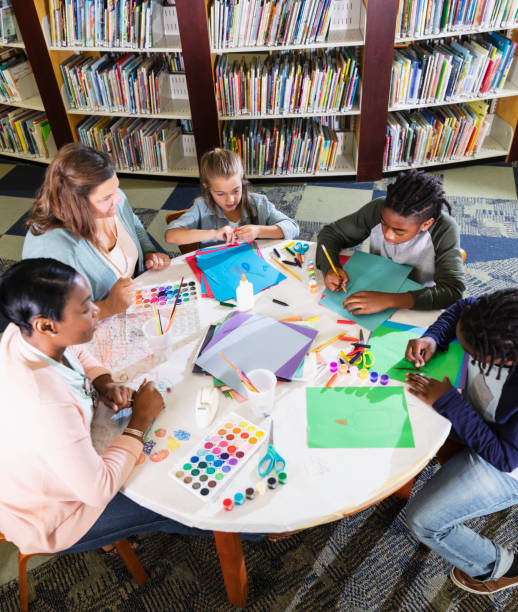 istock Children and mothers in library doing arts and crafts 1454259218