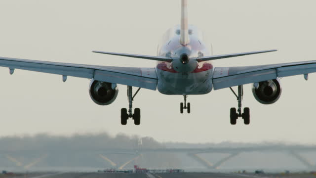 Camera Tilting To Follow Jet Landing On Runway