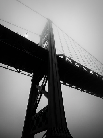 The Ambassador bridge links Detroit, Michigan with Windsor, Ontario.  It is one of the busiest trade routes in North America.  This photo was taken from Windsor, Ontario, Canada, during a foggy winter evening.