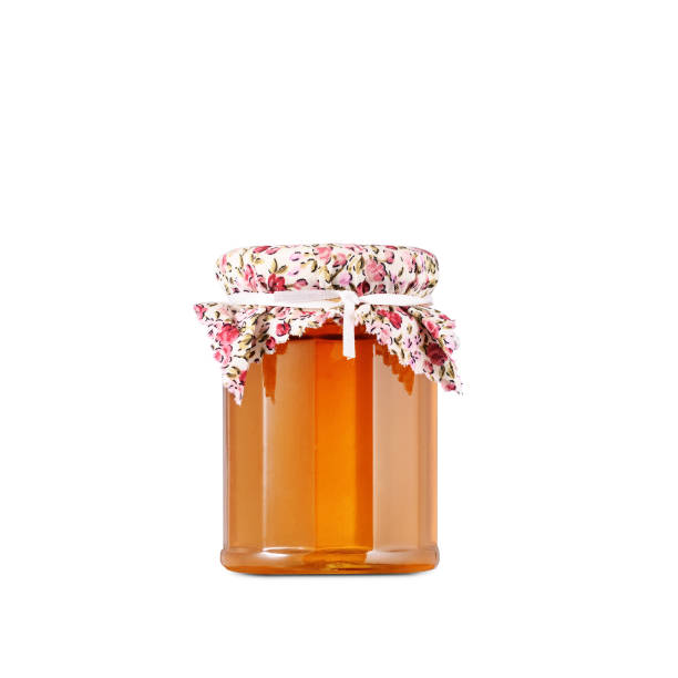 glass jar of honey isolated on white background stock photo