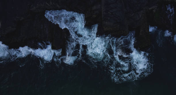 istock big waves crashing on the rocks 1454261362
