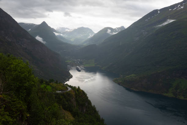 Nice scenic views of the high cliffs and deep waters of the beautiful UNESCO Geiranger Fjord stock photo