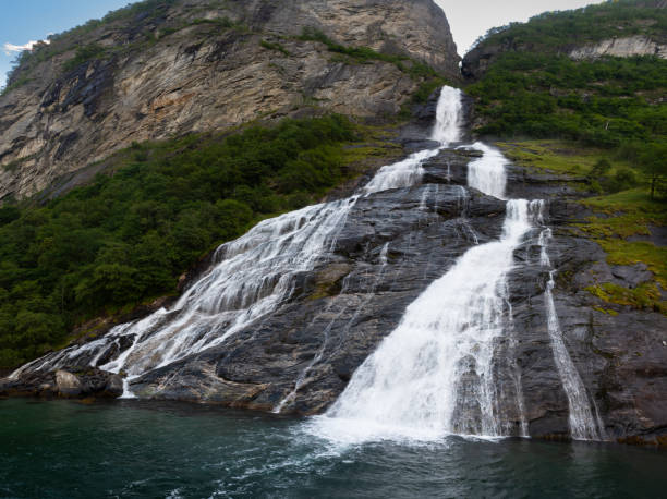 The famous and impressive waterfall The Suitor (Friaren) dropping down the rocks into the Geiranger Fjord stock photo