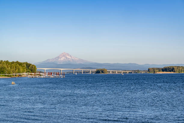 istock Long transport concrete interstate Glenn L Jackson Memorial Bridge over the Columbia River overlooking Mount Hood 1454264110