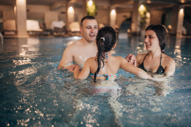 istock Family in hotel swimming pool 1454266069