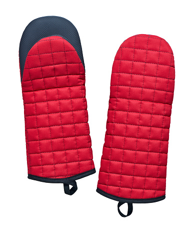 Red fabric quilted oven mitts with silicone inserts isolated