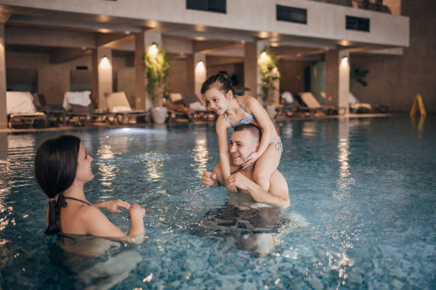 istock Family fun in hotel swimming pool 1454267020