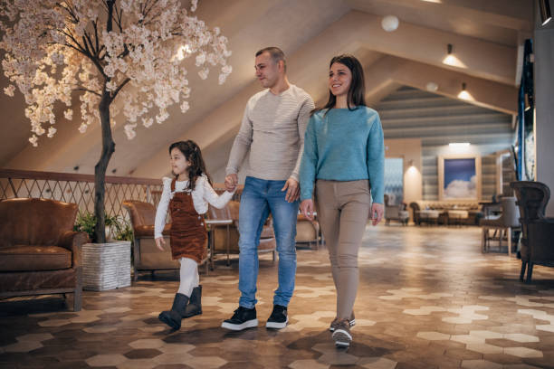 istock Family walking in hotel lobby 1454267183