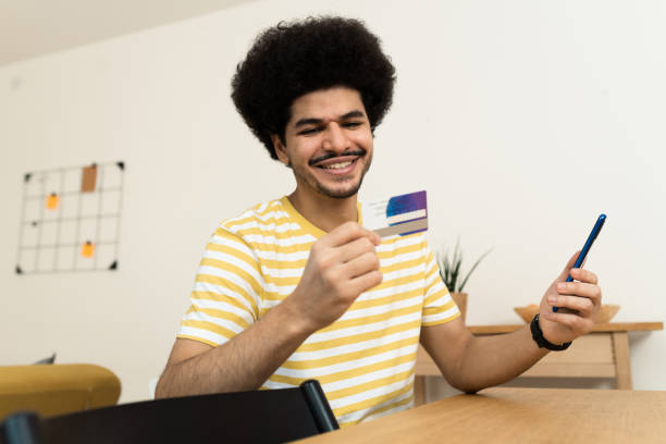 istock Man shopping online at home 1454268858