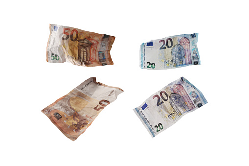 Used and crumpled fifty and twenty euro banknotes isolated on a white background, finance concept for money themes, business, investment or lottery, selected focus