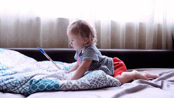 istock Baby learns to play on penny whistle at home. 1454276300