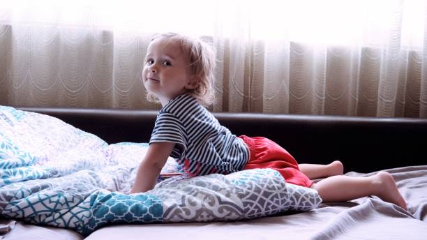 istock Baby learns to play on penny whistle at home. 1454276306