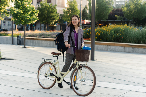 Asian businesswoman going to work by a bicycle