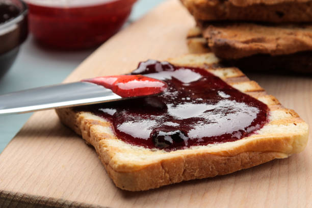 istock toasts with jam. fried crispy toast with red jam on a blue wooden table. breakfast. close-up 1454276695