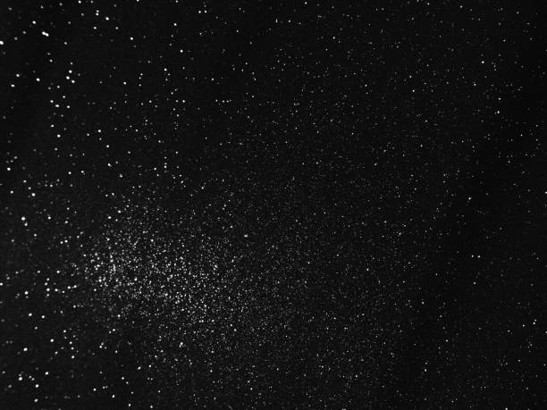 istock Black bokeh texture on black background. White glitter or illuminated dust 1454276714